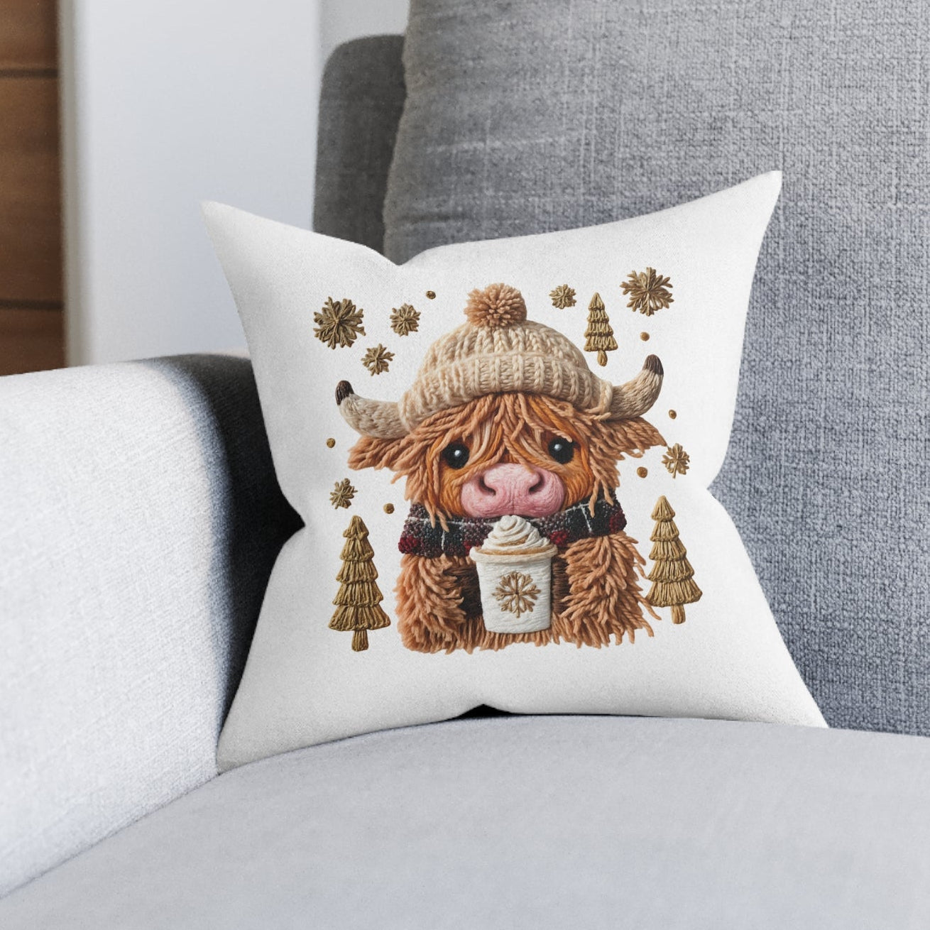 Decorative pillow with a cartoon cow design on a gray sofa.