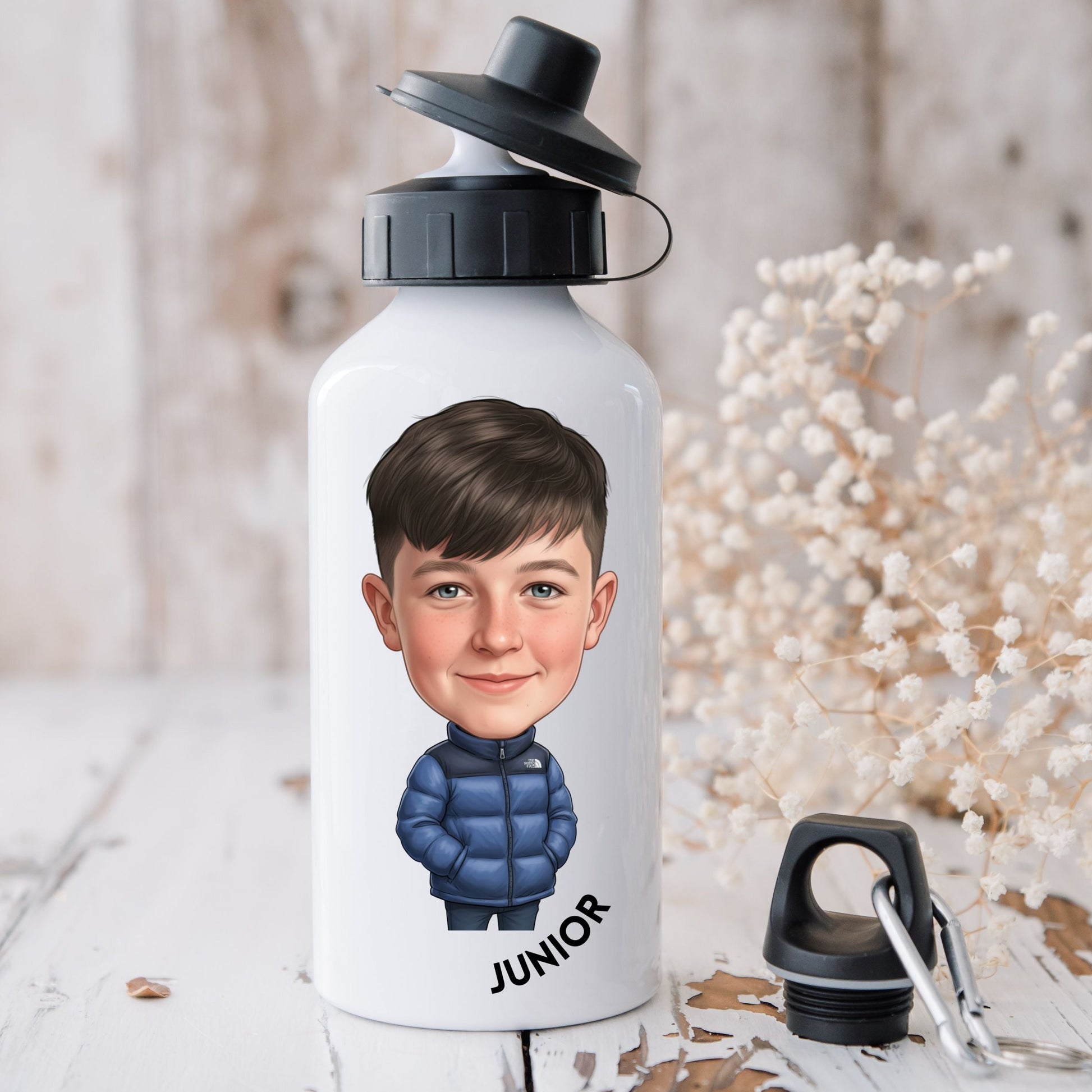 White water bottle with a printed face and 'Junior' text on a wooden surface with decorative elements.